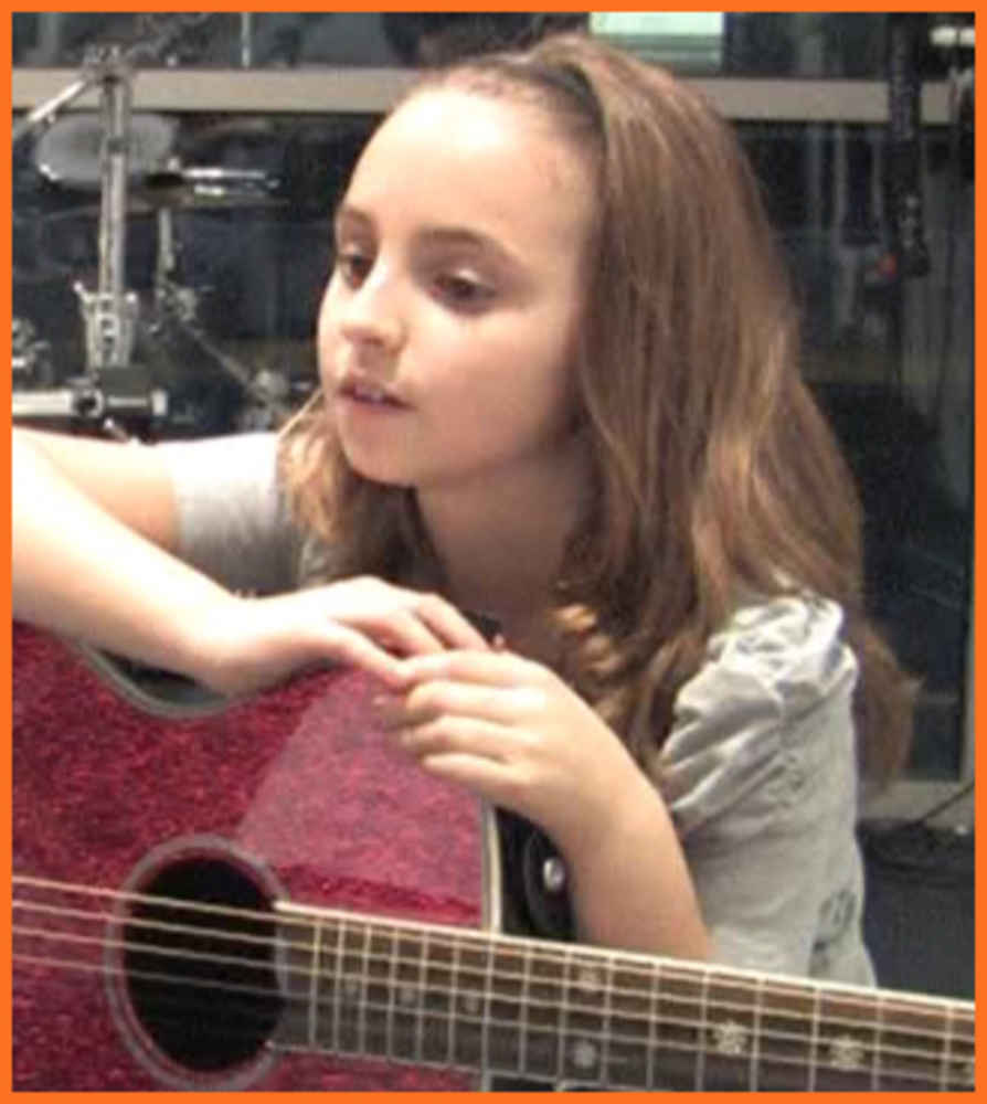 ></p><p ><b>Paige P</b> is Bach to Rock’s Student of the Month for January 2013. She attends B2R South Riding, Virginia. Aaron Sefchick is Paige’s instructor for private guitar lessons. In addition to the guitar, she enjoys singing and writing her own songs. The background music for this video contains portions of an original song written by Paige.</p><p><iframe width=
