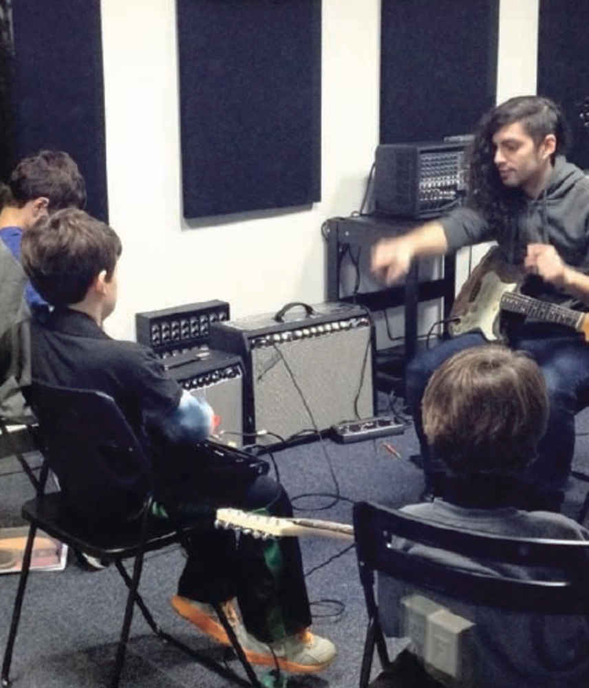 ></p>
<p>Bach to Rock, which opened in Port in January, already has over 250 students, ages 3 to a woman in her 80's. Owners Glenn Fleischman and Alan Goodstadt created the school with the intention of becoming the "center of the recreational music community," Fleischman said. "We really offer something to everybody. Not only lessons for children and adults, but the recording studio, the rehearsal studio, the open jam nights, and we sponsor local events around town."</p>
<p>Fleischman described their school as "Willy Wonka's chocolate factory for musicians." Along with several rooms for individual and group lessons, there is a performance room, which was "built with the intention to simulate a small club," said Goodstadt. "We like to give the kids the full rock star experience." The school has a full professional recording studio, which is used for birthday parties as well as local bands and students. "Part of the curriculum for the student bands is to get a professional recording done, which is a real bonus," said Fleischman.</p>
<p>The Bach to Rock school offers a curriculum which gives teachers structured guidelines as well as allowing students to experience music from different genres. "The books we use provide structure to help keep the teacher and the student focused," said Goodstadt. Each level has certain skills and methods that students must learn before moving up a level, like karate belt style.</p>
<p>Their staff includes a very talented group of hand picked teachers. "They're all active, gigging, touring musicians," said Goodstadt. "That gives them an experience that they can pass on to the kids that a lot of teachers can't."</p>
<p>Back to Rock also provides a music therapy program. "It uses music to teach and help life skills. For example, it teaches children on the autism spectrum eye contact, social cues, how to better engage in dialogue and improve speech through music," Fleischman explained. The music therapist they have on site is board certified with a master's degree in music therapy as well as being a talented musician in her own right.</p>
<p><img decoding=