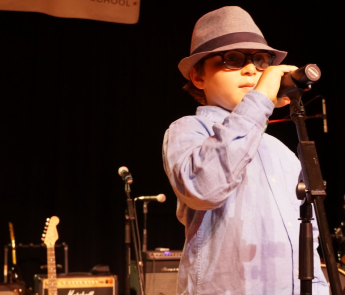 ></p>
<p>Bach to Rock Port Washington student Braden Blacker commands the microphone at the music education school’s Music Showcase. Blacker enjoyed performing for an audience of fellow students and parents.</p>
			</div><!-- .entry-content -->
		</article><!-- #post-->
	</div>

										
					<div class=