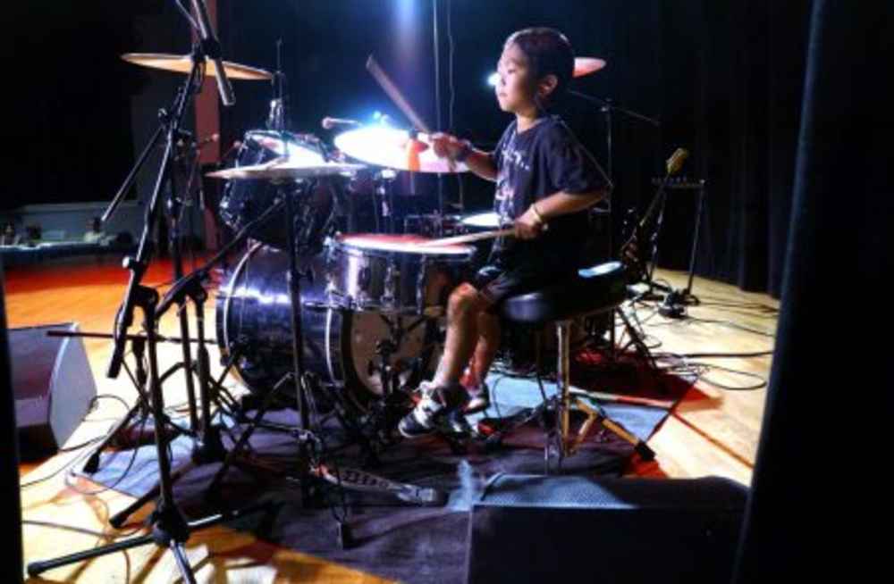 ></p>
<p>Max Kabot rocks a mean beat at the Music Showcase presented by Bach to Rock students.</p>
<p><img decoding=