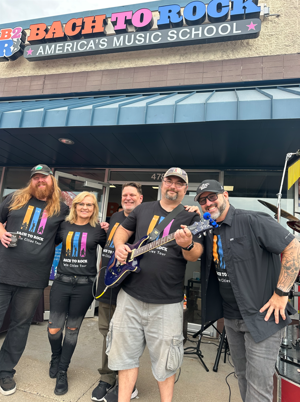 From left: Adam Durand, B2R Coon Rapids; Judy Shoulak; Don Zbinden, B2R Minnetonka; Jake Shoulak and Chris Hawkey, country music star & KFAN celebrity, celebrate the opening of Bach to Rock’s 25th multi-unit location.