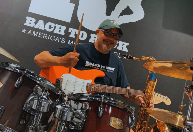 bach to rock music school franchise owner playing drums